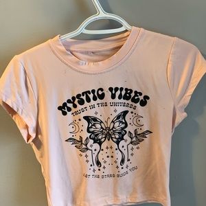 Pink “Mystic Vibes” tee.